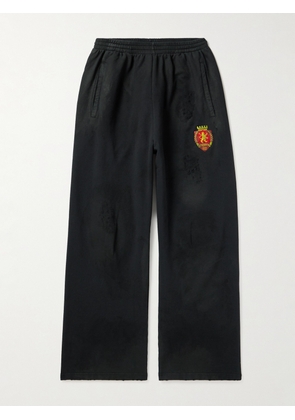 Balenciaga - Wide-Leg Distressed Logo-Appliquéd Cotton-Jersey Sweatpants - Men - Black - S