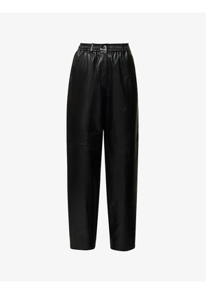 Elasticated-waist exposed-seam tapered high-rise leather trousers