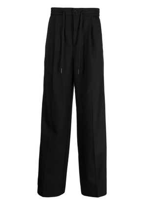 Holzweiler pressed-crease tailored trousers - Black