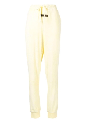 FEAR OF GOD ESSENTIALS logo-patch detail track pants - Yellow