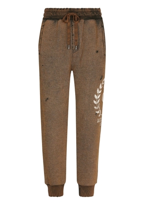 Dolce & Gabbana logo-print ripped track pants - Brown