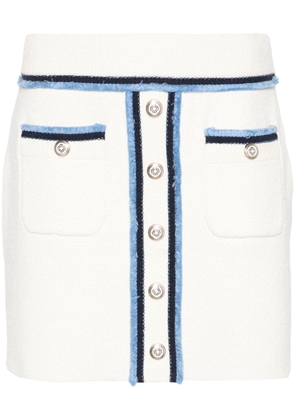 Maje decorative-buttons bouclé miniskirt - White