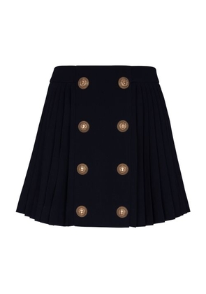 Pleated skirt with double buttoning