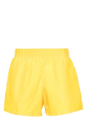 Moschino logo-embossed swim shorts - Yellow