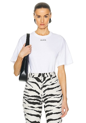 ALAÏA Fluid T-shirt Bodysuit in Blanc & Noir - White. Size 34 (also in 38, 40).