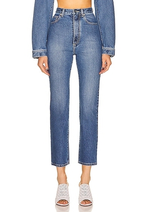 ALAÏA High Waisted Jean in Blue Jean - Blue. Size 40 (also in ).