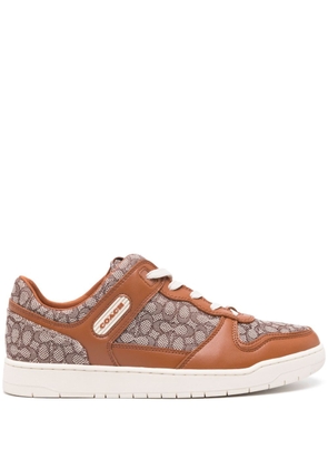Coach monogram-pattern lace-up sneakers - Brown