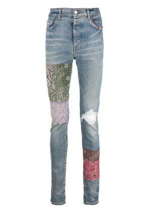 AMIRI distressed patchwork skinny jeans - Blue