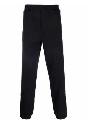 Prada logo-stripe ankle-zip trousers - Black