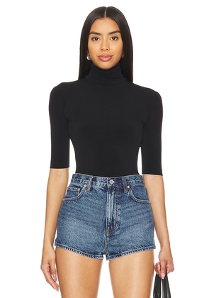 Norma Kamali Slim Fit Short Sleeve Turtleneck Top in Black. Size M, S, XL, XS, XXS.