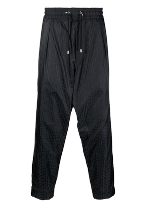 Balmain monogram-print tapered trousers - Black
