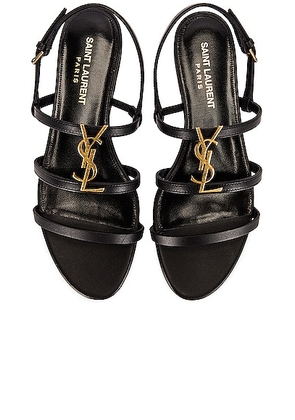 Saint Laurent Cassandra Leather Flat Sandals in Nero - Black. Size 36.5 (also in 36, 37, 37.5, 38.5, 39.5, 40, 40.5, 41, 42).