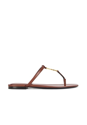 Saint Laurent Cassandra Flat Sandal in Aesthetic Brown - Brown. Size 36 (also in 37, 37.5, 38, 38.5, 39, 39.5, 40, 40.5, 41).