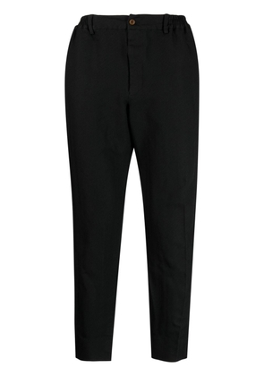 Black Comme Des Garçons chevron-pattern tapered trousers
