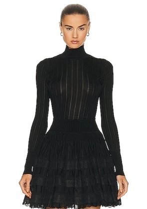 ALAÏA Turtleneck Sweater in Noir ALA?A - Black. Size 34 (also in 44).