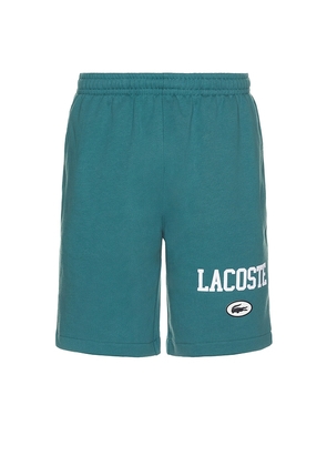 Lacoste Adjustable Short in Teal. Size 4, 5, 6.