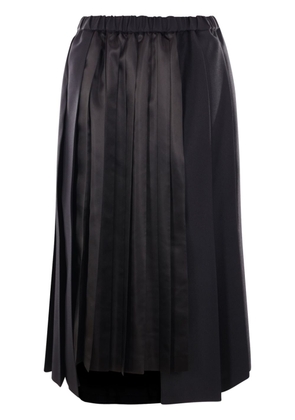 Black Comme Des Garçons asymmetric pleated skirt