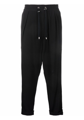 Balmain slouchy crepe tapered-leg track pants - Black