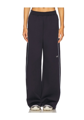 WE11DONE Track Pants in Navy. Size L. Also in S.