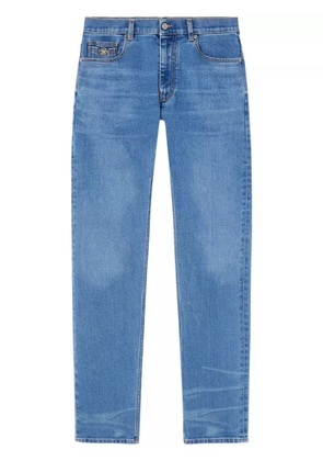Versace Medusa Head-embellished mid-rise slim-fit jeans - Blue