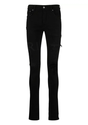 AMIRI ripped-knee logo-print skinny jeans - Black