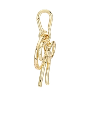 BaubleBar Bow Bag Charm in Metallic Gold.