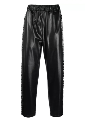 Junya Watanabe Comme des Garçons Pre-Owned x Keith Haring graphic-print track pants - Black