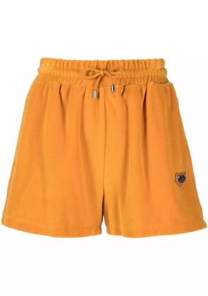 Philipp Plein velvet-effect logo-plaque track shorts - Yellow