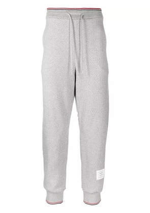 Thom Browne herringbone-pattern logo-patch track pants - Grey