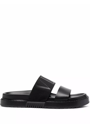 Valentino Garavani logo-embossed leather slides - Black