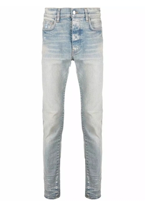 AMIRI logo-patch stonewashed skinny jeans - Blue