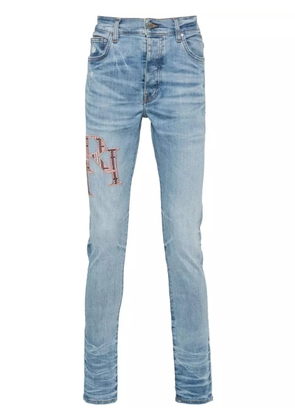AMIRI logo-embroidered skinny jeans - Blue