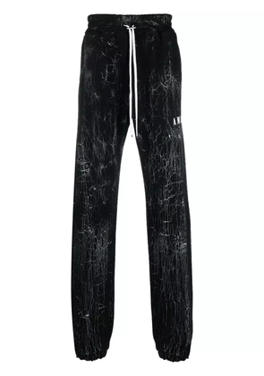 AMIRI cracked-dye logo track pants - Black