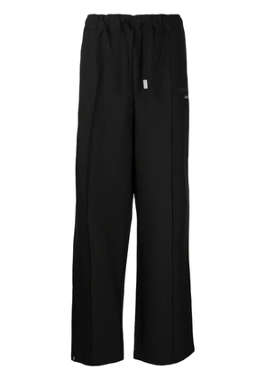 izzue logo-plaque straight-leg trousers - Black
