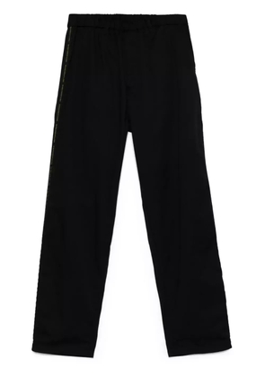 Undercover logo tape-detail trousers - Black