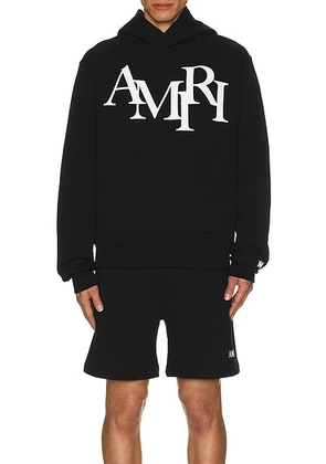 Amiri Staggered Logo Hoodie in Black - Black. Size M (also in L, S, XL, XXL).