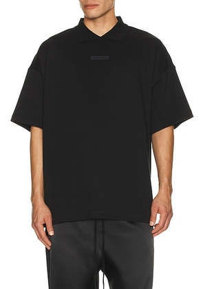 Fear of God ESSENTIALS 90s Fit Pique Polo in Jet Black - Black. Size L (also in M, S, XL/1X).