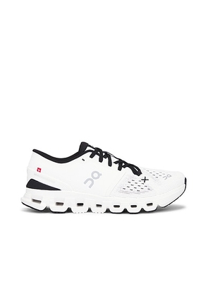On Cloud X 4 Sneaker in Ivory & Black - Ivory. Size 10 (also in 5, 5.5, 6, 6.5, 7, 7.5, 8, 8.5, 9, 9.5).