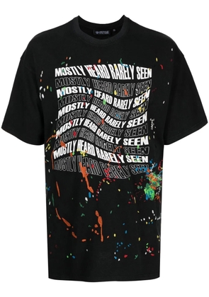 Mostly Heard Rarely Seen Warped-Logo paint-splatter T-shirt - Black