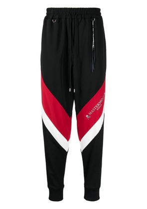 Mastermind World logo-print stripe-detailing track pants - Black
