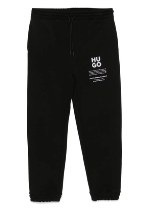 HUGO logo and slogans print track pants - Black