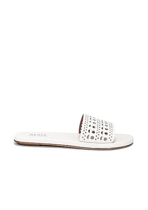 ALAÏA Perforated Flat Sandal in Blanc Casse - White. Size 40 (also in 37).