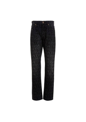 Versace All-Over Logo Denim Jeans