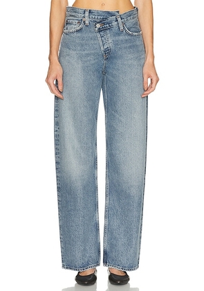 AGOLDE Arc Criss Cross Jeans in Conclusion - Blue. Size 23 (also in 24, 25, 26, 27, 28, 29, 30, 31, 32, 33, 34).