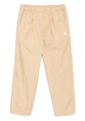 AAPE BY *A BATHING APE® logo-patch trousers - Neutrals