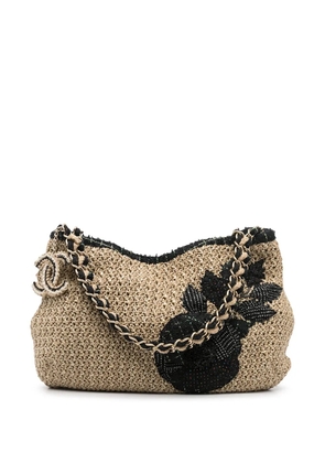 CHANEL Pre-Owned Camélia patch woven shoulder bag - Neutrals