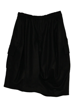 Black Comme Des Garçons asymmetric pocket skirt