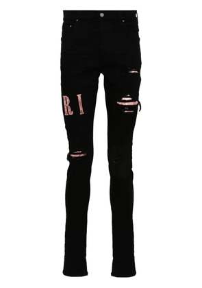 AMIRI waxed logo-appliqué skinny jeans - Black