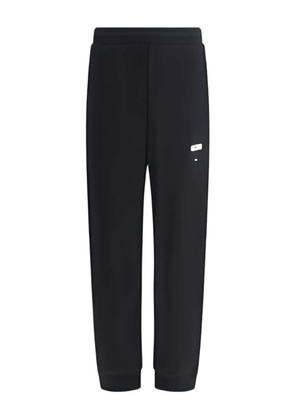 Moschino logo-print cuffed trousers - Black