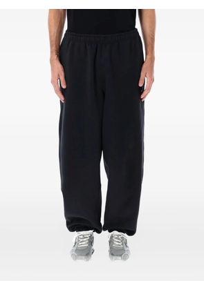 Nike swoosh-embellished track pants - Black